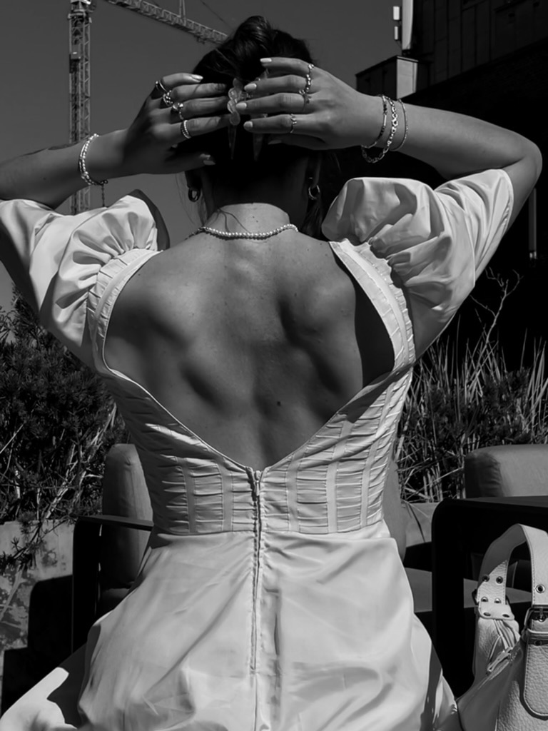 Victoria Clara Swart photographed from behind on a rooftop, black and white